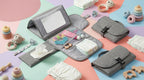 A gray fabric baby diaper bag organizer shown open and closed on a pastel multicolor background, surrounded by baby accessories including diapers, wipes, pacifiers, teething toys, and a small mirror.